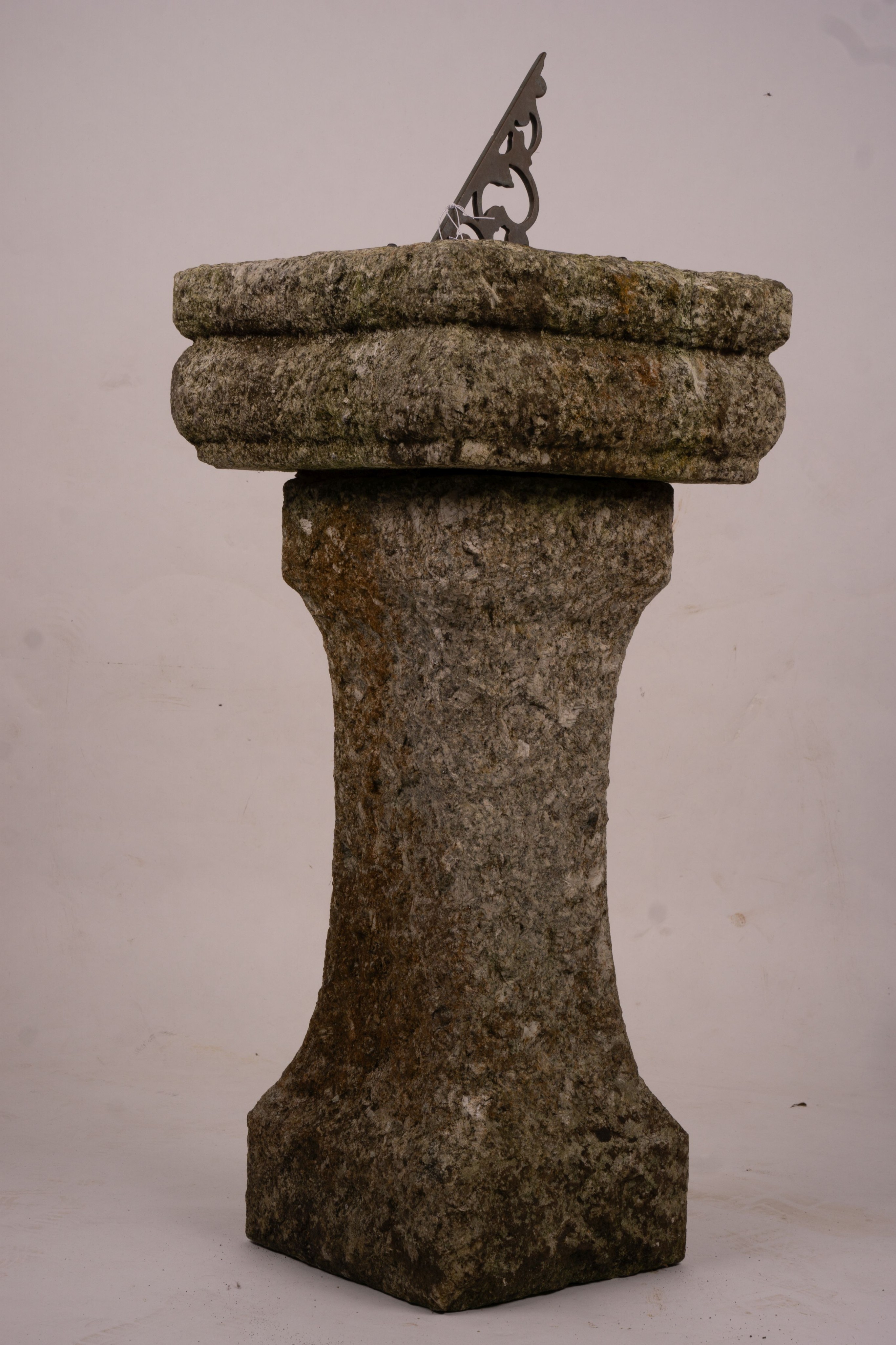 An octagonal sundial on reconstituted stone plinth, height 92cm